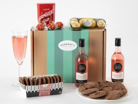 Burmont’s Exclusive Rosé Wine & Chocolate Hamper featuring two small rose wines and a variety of premium chocolates including Lindt Lindor, Ferrero Rocher, and chocolate chip biscuits.